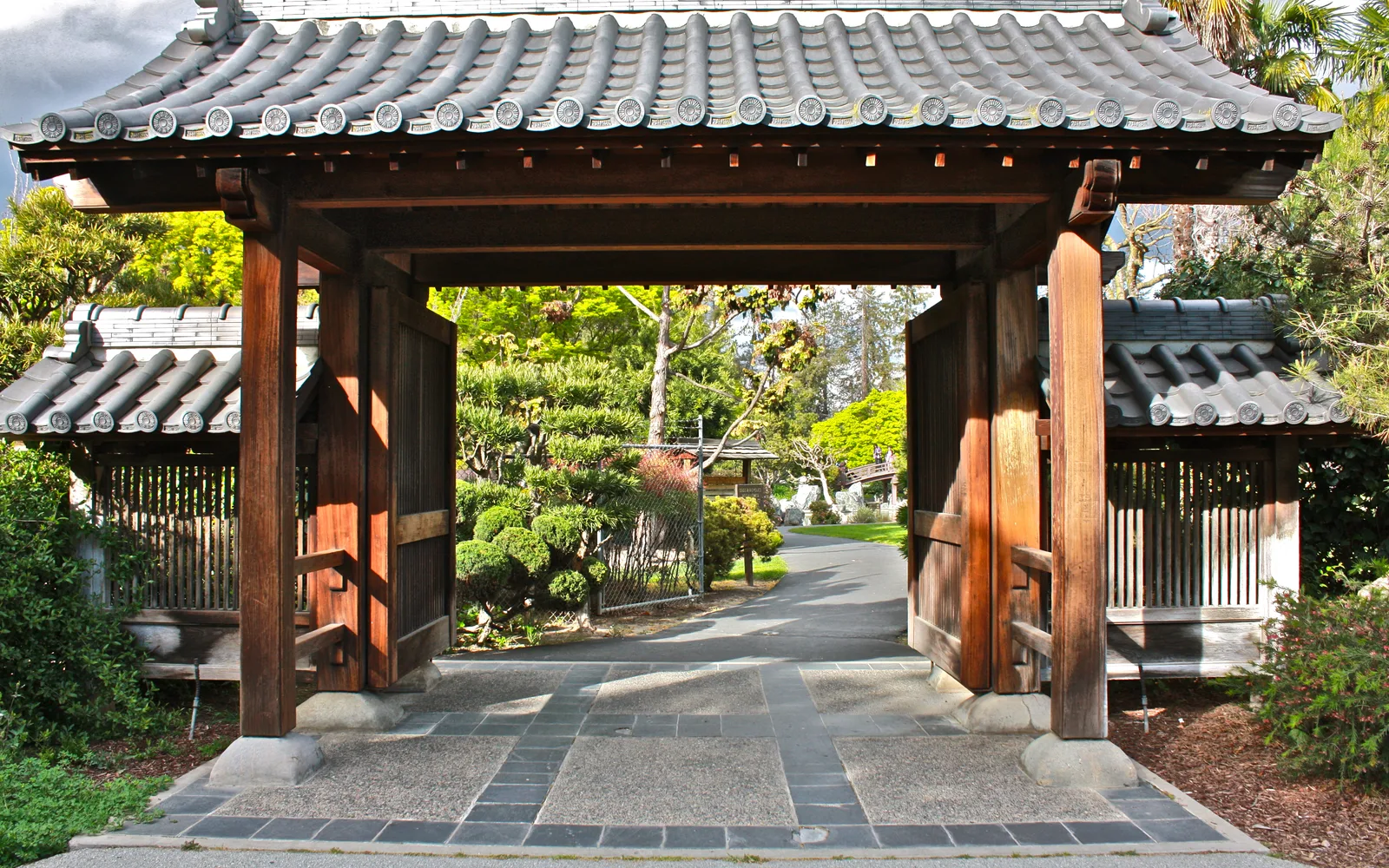 The entrance to the Japanese Friendship Garden at Kelley Park, showing landscaped gardens and architectural design representing the Bay Area's arts and culture.